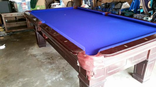Blue felt pool table with wood base